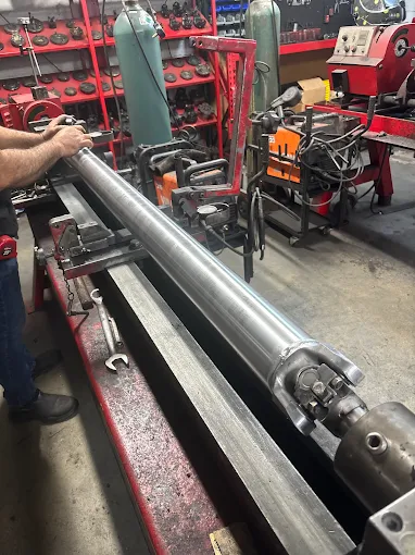 Technician working on driveshaft in the workshop